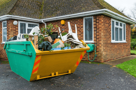 Skip in front of a house